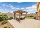 Backyard features an outdoor pergola with covered seating area at 1437 W Smoke Tree Ave, San Tan Valley, AZ 85140