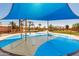 Community splash pad with colorful designs and shade, offering fun for all at 1437 W Smoke Tree Ave, San Tan Valley, AZ 85140