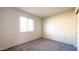 Neutral bedroom with window, carpet, and two electrical outlets with fresh paint at 1440 N Idaho Rd # 1008, Apache Junction, AZ 85119