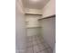 Walk-in closet with built-in shelving and tile flooring at 1633 E Lakeside Dr # 39, Gilbert, AZ 85234