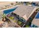 Aerial view of home with tile roof and backyard featuring covered patio and seating area at 1808 E Crocus Ave, Queen Creek, AZ 85140