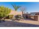 Beautifully landscaped backyard featuring lush greenery, palm trees and a built-in BBQ at 1808 E Crocus Ave, Queen Creek, AZ 85140