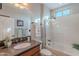 Bright bathroom featuring granite countertop, wood cabinet, and bathtub with shower at 1808 E Crocus Ave, Queen Creek, AZ 85140