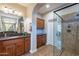 Bathroom showcasing a vanity, storage, and a glass shower with decorative tile at 1808 E Crocus Ave, Queen Creek, AZ 85140