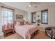 Bedroom with neutral walls, cozy carpet, windows, and an accent chair at 1808 E Crocus Ave, Queen Creek, AZ 85140