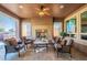 Cozy covered patio with fireplace, ceiling fan, recessed lighting, and comfortable seating at 1808 E Crocus Ave, Queen Creek, AZ 85140