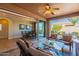 View of the covered patio, dining room and back yard with seating area at 1808 E Crocus Ave, Queen Creek, AZ 85140