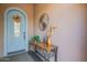 Home entryway featuring a decorative front door and a console table with floral accents at 1808 E Crocus Ave, Queen Creek, AZ 85140