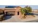 Aerial view of a home featuring a landscaped yard, two-car garage, and installed solar panels at 1808 E Crocus Ave, Queen Creek, AZ 85140