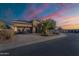 Charming stucco and brick home with desert landscaping, solar panels, and an attached two-car garage at 1808 E Crocus Ave, Queen Creek, AZ 85140