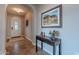 Inviting foyer with tile flooring, an arched doorway, and a decorative table with wall art at 1808 E Crocus Ave, Queen Creek, AZ 85140