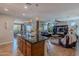 Open concept kitchen with a granite island, pendant lights, and view into the living and dining areas at 1808 E Crocus Ave, Queen Creek, AZ 85140