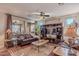 Bright living room with large windows, comfortable furniture, and hardwood floors at 1808 E Crocus Ave, Queen Creek, AZ 85140