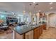 Open concept living room and kitchen with hardwood floors and stainless steel appliances at 1808 E Crocus Ave, Queen Creek, AZ 85140