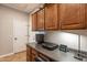 Home office with built-in cabinets, workspace, and overhead lighting at 1808 E Crocus Ave, Queen Creek, AZ 85140