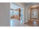 Open home office space with built-in shelving and front door view at 1808 E Crocus Ave, Queen Creek, AZ 85140