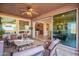 Covered patio featuring comfortable seating, a ceiling fan, and views of interior rooms at 1808 E Crocus Ave, Queen Creek, AZ 85140