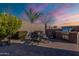 Outdoor dining space with a brick-paved patio, built-in grill, privacy walls, and a desert view at 1808 E Crocus Ave, Queen Creek, AZ 85140