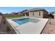 Beautiful backyard with a refreshing pool and well-manicured landscaping and artificial grass at 18509 W Galveston St, Goodyear, AZ 85338