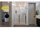 Bathroom featuring a walk-in shower and direct access to the laundry room at 18509 W Galveston St, Goodyear, AZ 85338