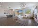 Open-concept living room with dining area, fireplace, and a view of the backyard pool at 18509 W Galveston St, Goodyear, AZ 85338