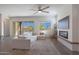 Spacious living room featuring a fireplace, large windows, and sliding glass doors at 18509 W Galveston St, Goodyear, AZ 85338