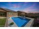 Beautiful pool with lounge chairs, lush landscaping, and a view of the house at dusk at 18509 W Galveston St, Goodyear, AZ 85338
