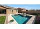 Beautiful pool with lounge chairs, lush landscaping, and a view of the house at 18509 W Galveston St, Goodyear, AZ 85338