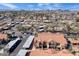 Wide aerial shot of residential community showcasing red tiled roofs, carports, landscaping, and a city skyline at 1905 E University Dr # 216, Tempe, AZ 85288