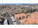 Aerial view of residential community, featuring red tile roofs, covered parking, landscaping, and city skyline in background at 1905 E University Dr # 216, Tempe, AZ 85288
