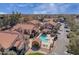 Aerial view of neighborhood with community pool, clubhouse, assigned parking and Southwestern style architecture at 1905 E University Dr # 216, Tempe, AZ 85288