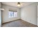 Bright bedroom featuring neutral carpet, ceiling fan, and large window at 1905 E University Dr # 216, Tempe, AZ 85288