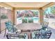 View of a community pool and lounge area from a covered patio with dining table and chairs at 1905 E University Dr # 216, Tempe, AZ 85288