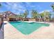 Community pool area with a covered seating area, clear blue water, lounge chairs, and mature shade trees at 1905 E University Dr # 216, Tempe, AZ 85288