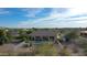 Aerial view of a home featuring a pool, covered patio, desert landscaping, and mountain views at 19910 W Amelia Ave, Buckeye, AZ 85396