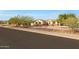 Street view of a single-story home with desert landscaping and tasteful stone accents at 19910 W Amelia Ave, Buckeye, AZ 85396