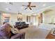 Spacious living room featuring ceiling fans, arches, and comfortable leather seating at 19910 W Amelia Ave, Buckeye, AZ 85396