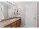 Bathroom with granite countertop and wood cabinets at 21004 N 53Rd Ave, Glendale, AZ 85308