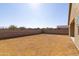 A large, bare backyard featuring block walls, ready to be designed at 34395 N Cherrystone Dr, San Tan Valley, AZ 85144