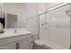 Modern all-white bathroom featuring a glass shower, a sleek mirror, and a pristine vanity at 34395 N Cherrystone Dr, San Tan Valley, AZ 85144