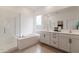 Bathroom features a soaking tub, walk-in shower, double vanity, and modern fixtures at 34395 N Cherrystone Dr, San Tan Valley, AZ 85144