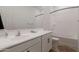Bright bathroom featuring a large mirror, all white cabinets, and a shower/bathtub combo at 34395 N Cherrystone Dr, San Tan Valley, AZ 85144
