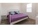 Bedroom showcasing a purple comforter on a white metal frame bed with two green pillows at 34395 N Cherrystone Dr, San Tan Valley, AZ 85144