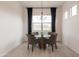 Bright dining room features modern chandelier, round glass table and four stylish woven chairs at 34395 N Cherrystone Dr, San Tan Valley, AZ 85144