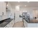 This kitchen is bright and airy with sleek appliances, dark countertops, white cabinetry, and an island at 34395 N Cherrystone Dr, San Tan Valley, AZ 85144