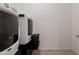 Laundry room showcases a Maytag washer and dryer with a dark rack and laundry basket at 34395 N Cherrystone Dr, San Tan Valley, AZ 85144