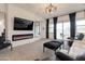 This modern living room features a fireplace, plush seating, large windows, and neutral decor at 34395 N Cherrystone Dr, San Tan Valley, AZ 85144