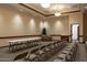 Large meeting room with tan walls, rows of chairs, a table, and a leather sofa at 34395 N Cherrystone Dr, San Tan Valley, AZ 85144