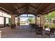 Covered outdoor seating area with stone pillars and views of the community pool at 34395 N Cherrystone Dr, San Tan Valley, AZ 85144