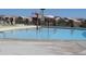 Close-up shot of community pool with a fun splash pad on a sunny day at 34395 N Cherrystone Dr, San Tan Valley, AZ 85144